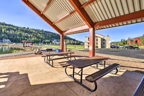 a group of picnic tables and benches on a patio at Ski-InandSki-Out Brian Head Condo with Hot Tub! in Brian Head