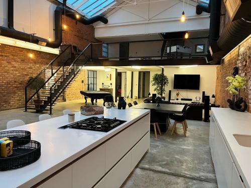 an open kitchen and living room with a piano at Bedford Street Lofts in Leamington Spa