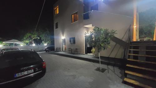 a car parked in front of a building at night at Guest House Tian & Hojz in Durrës