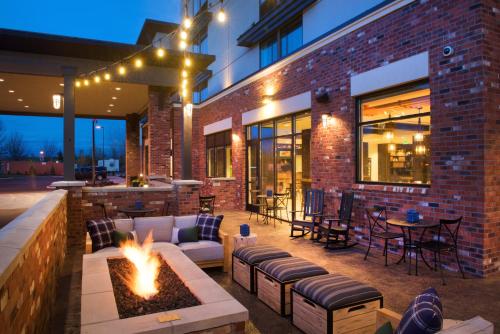 a patio with a fire pit in front of a building at SpringHill Suites by Marriott Bend in Bend