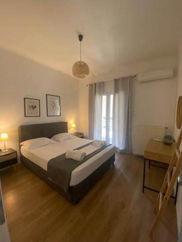 a bedroom with a large bed and a window at Menta House in Lefkada