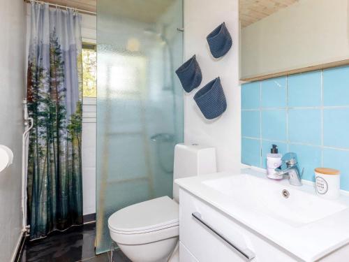 a bathroom with a toilet and a sink and a shower at Holiday home Bindslev XXII in Bindslev