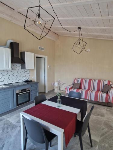 a living room with a table and a couch at A Baracca du Pei in Imperia