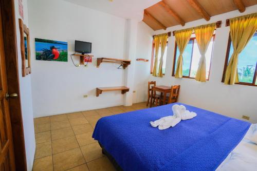 Cama o camas de una habitación en Galapagos Verde Azul