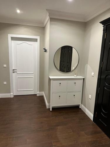 a room with a white dresser and a mirror at Apartment Fourty One in Al Khobar