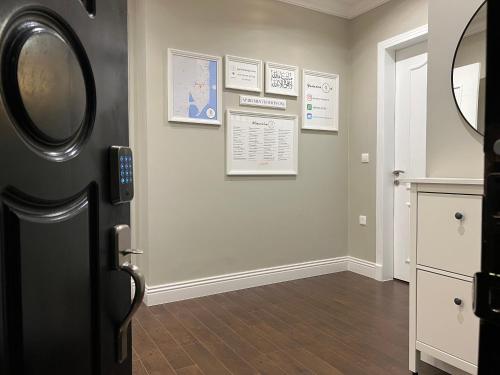 a hallway with a door and some pictures on the wall at Apartment Fourty One in Al Khobar