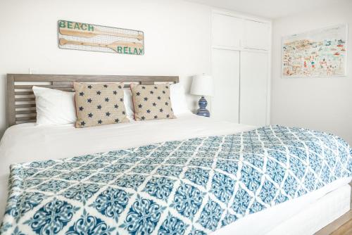 a bedroom with a bed with a blue and white comforter at CB-2445C - Carlsbad Casa De Los Sueños | Unit C in Carlsbad