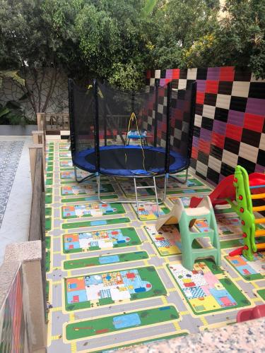 a playground with a trampoline and a play set at Eden Appartement avec Piscine Et Salle de Sport in El Jadida