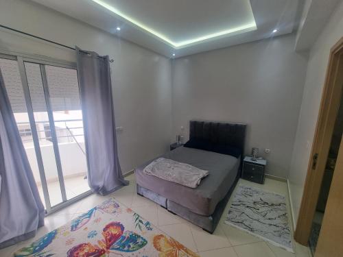 a small bedroom with a bed and a window at Best Appertement in haut founty in Agadir