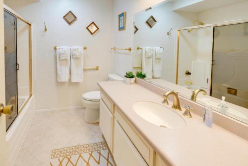 a bathroom with a sink and a toilet and a mirror at CB-5515 - Walk to Beach - Private Hot Tub - Ideal Location in Carlsbad