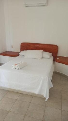 a white bed with two towels on it in a room at QUINTA DIAMANTE villas&hotel in Barra Vieja