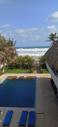 a swimming pool with a view of the beach at QUINTA DIAMANTE villas&hotel in Barra Vieja