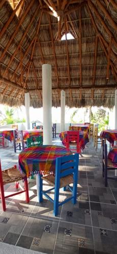 a group of tables and chairs in a building at QUINTA DIAMANTE villas&hotel in Barra Vieja