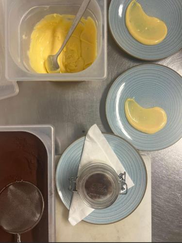 a table with blue plates and a container of food at LOCANDA PODERE LE VIGNE in Radda in Chianti