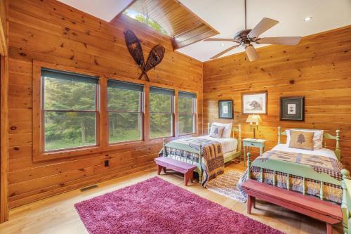 a bedroom with two beds and a ceiling fan at Platte Lake Paradise in Beulah