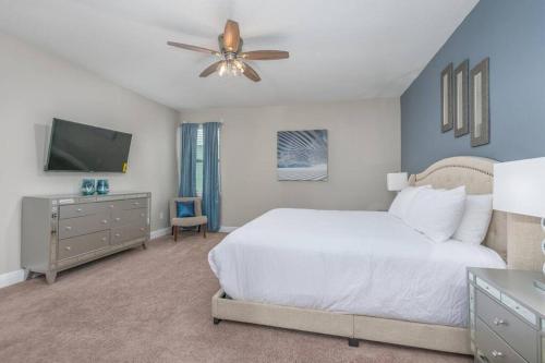 una camera con letto bianco e ventilatore a soffitto di Luxury 6 BR 6 Bath @Encore Resort Pool Spa Grill. a Orlando