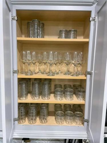 a cabinet filled with empty glasses in a room at Luxury 6 BR 6 Bath @Encore Resort Pool Spa Grill. in Orlando