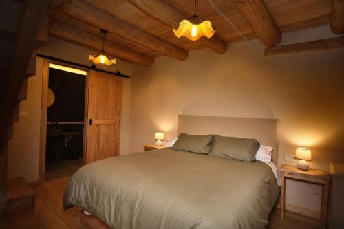 a bedroom with a bed with two lamps and a window at A Barreira -Lar da cima- in Folgoso
