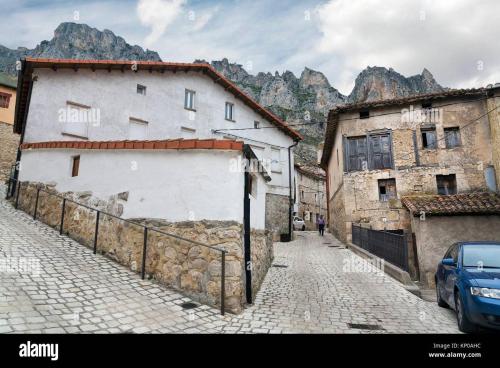 a cobblestone street in a town with mountains at PUENTECUERVO in Pancorbo