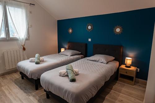 two beds in a room with blue walls at Escapade Mauriennaise in Saint Avre la Chambre