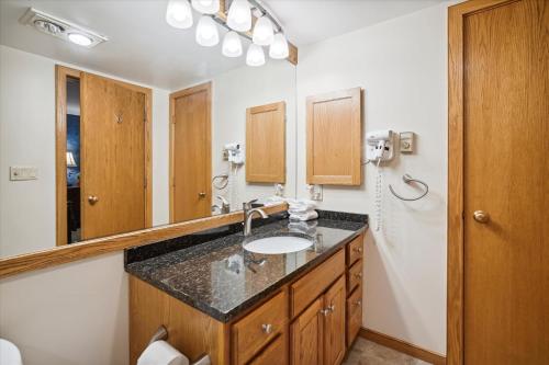 a bathroom with a sink and a mirror at Flawless two bedroom two bathroom, sleeps 6 Highridge D14 in Killington