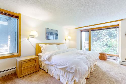 a bedroom with a large bed and a window at Mountain Haven Retreat in Stratton Acres