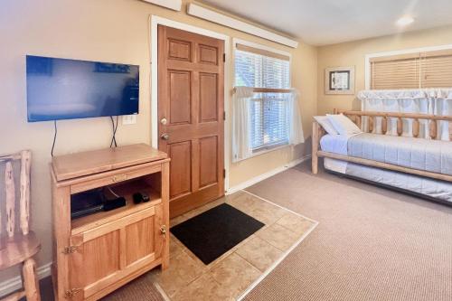 a living room with a flat screen tv and a couch at On the Rapids - A Unit in Grand Lake