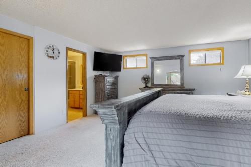 a bedroom with a bed and a television in it at Prime Cove Quarters in Oak Harbor