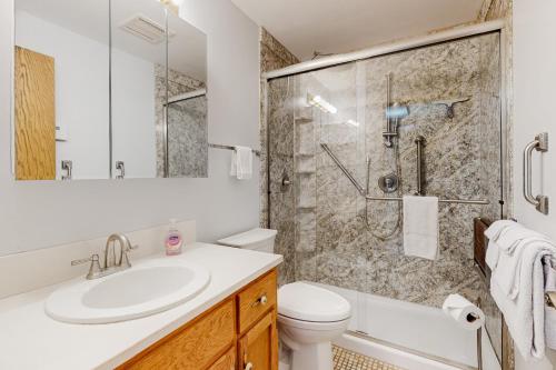 a bathroom with a sink and a toilet and a shower at Prime Cove Quarters in Oak Harbor