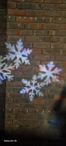 a reflection of a painting on a brick wall at Eden house in Hayes