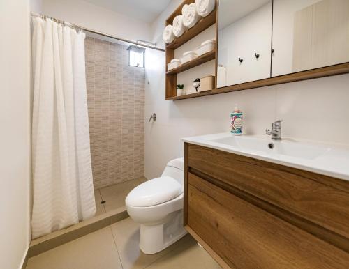a bathroom with a toilet and a sink and a shower at Barranco inolvidable BR1 in Lima