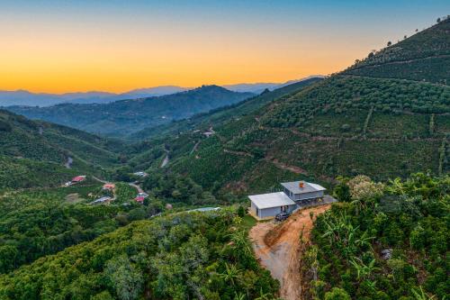 a house on the side of a hill with a valley at El Portal Tarrazu in Santa Cruz