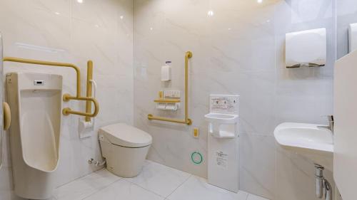 a bathroom with a toilet and a sink at Toyoko Inn Oyama-eki Higashi-guchi No.2 in Oyama
