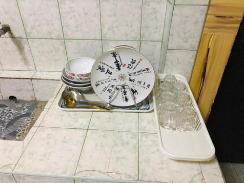 a clock sitting on a counter in a bathroom at Baguio Classic Cozy Home in Baguio