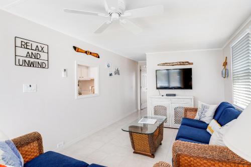 a living room with a couch and a tv at Dock Holiday in Cudjoe Key