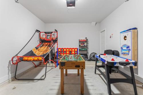 a room with two bunk beds and a ping pong table at Serenity Pearl Escape in Saint Augustine