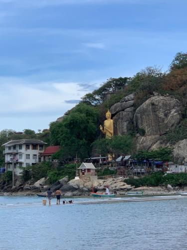 a group of people on the beach with a large statue at Nichahome Luxury Villa in Hua Hin