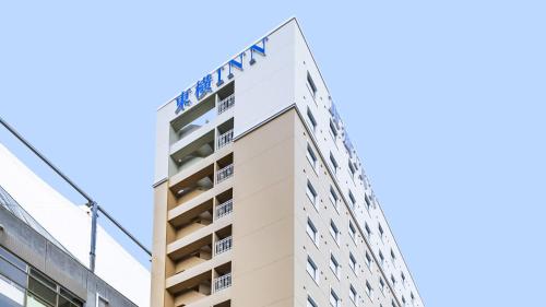 a building with the mgm sign on top at Toyoko Inn Kita-asaka-eki Nishi-guchi in Asaka