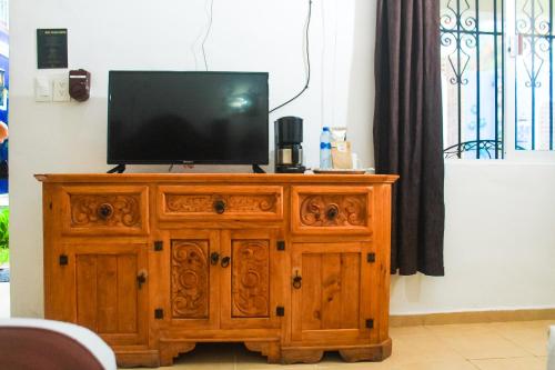 a wooden entertainment center with a television on top of it at Palacio Canton in Valladolid