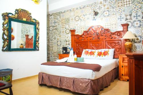 a bedroom with a large bed and a mirror at Palacio Canton in Valladolid