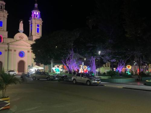 a church with cars parked in front of it at night at Hermosa y tranquila finca con piscina in Ginebra
