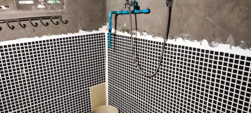a bathroom with a shower and a toilet at Tree Trails Homestay & Offers Jungle Trekk-Scooter For Rental in Banlung
