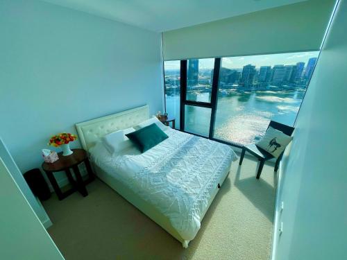 a bedroom with a bed and a view of the city at Yarra Accommodation in Melbourne