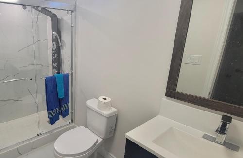 een badkamer met een toilet, een wastafel en een douche bij Lake-walk 3 Bed 2 Bath Apartment in Hamilton