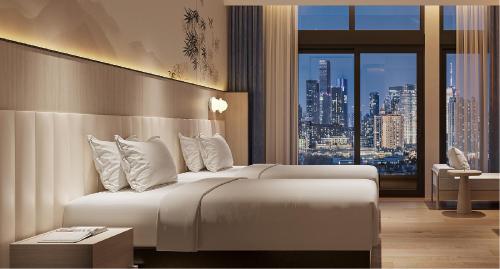 a hotel room with a bed and a view of a city at Guangzhou Drimin House Hotel - Canton Fair Free Shuttle Bus in Guangzhou