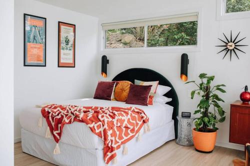 a bedroom with a white bed and a window at Retro Retreat - by Coast Hosting in Terrigal