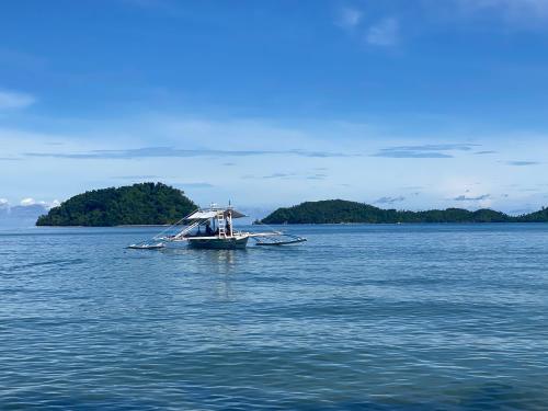 a boat in the middle of a large body of water at Amila Dive Beach Resort in Sipalay