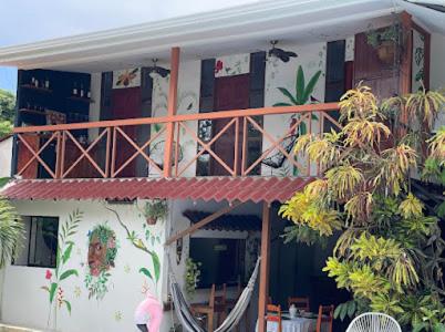 a building with a balcony with plants on it at Mecca in Puerto Viejo