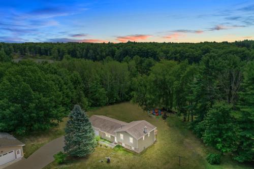 an aerial view of a house in the woods at LAKEFRONT PARADISE 4 bedroom Home w direct lake access, Pets OK in Traverse City