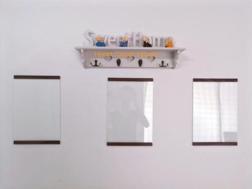a shelf on a wall with three windows at Heart Bentong Guest House 文冬心宿民宿 Bentong Homestay in Bentong